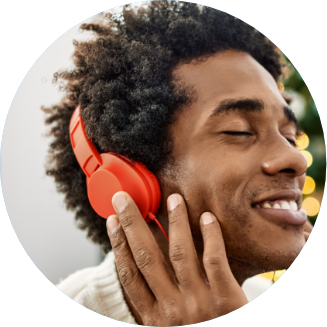 smiling man with headset listening to music